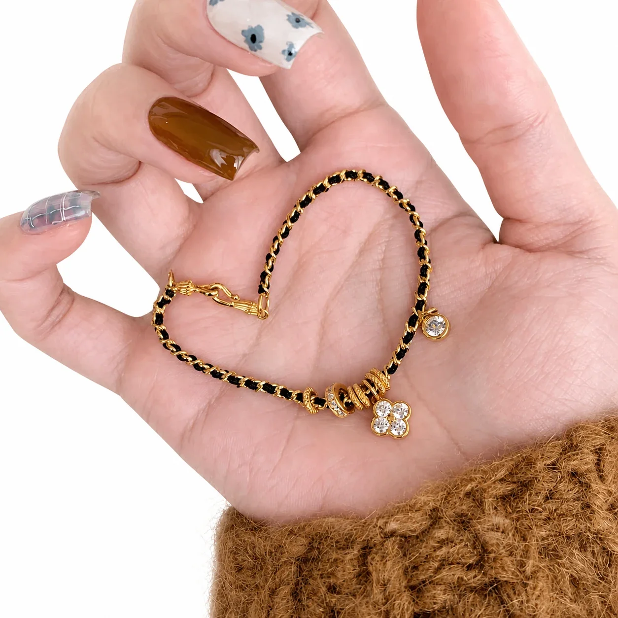 Ornate Gold-Plated Black Woven Clover CZ Copper Bracelet